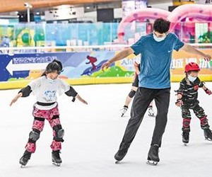 7月26日，在石家庄天山海世界滑冰场，小学员在教练的指导下练习花样滑冰基本技术。